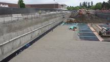 Dewatered excavation installing underdrains